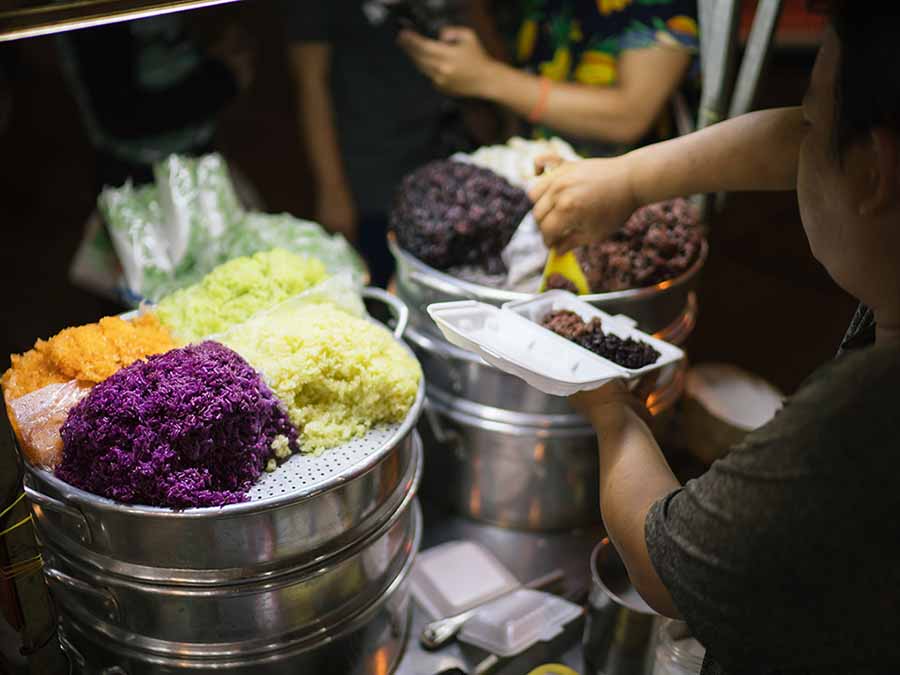 A variety of xoi types displayed in a street food stall